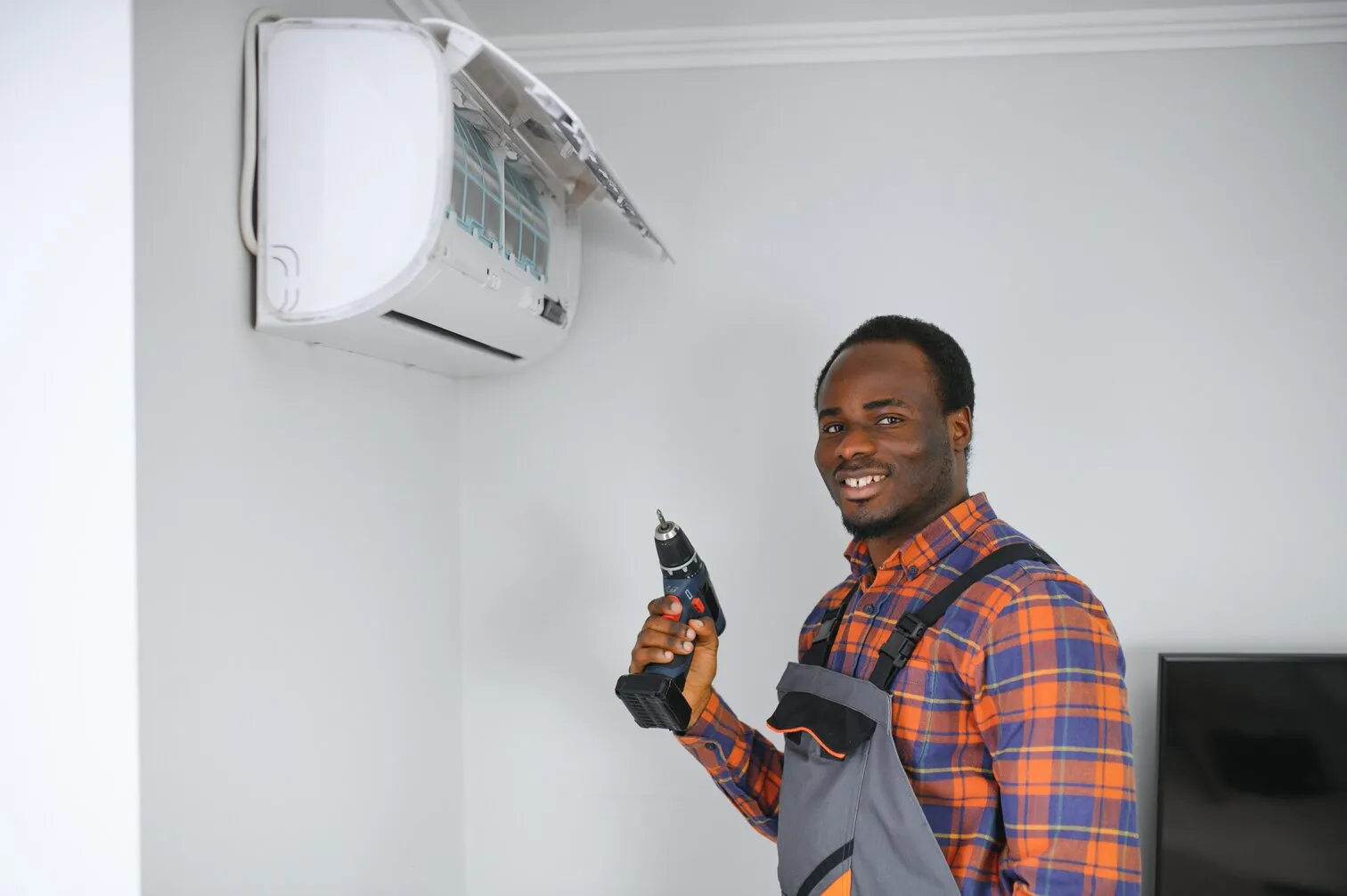 HVAC Technician working on AC Unit