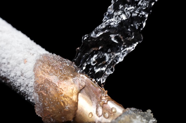 copper pipe covered in ice and bursting