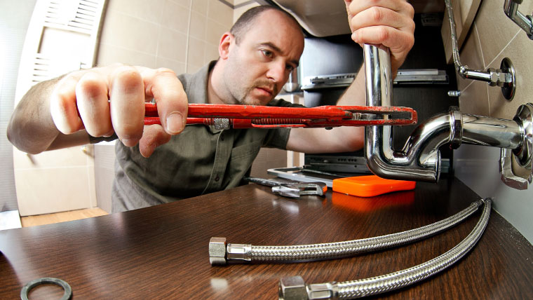 tech fixing a pipe Call Alco Air today at (903) 417-0260 for professional leak detection and repair services.