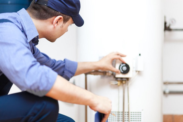 technician adjusting water heater