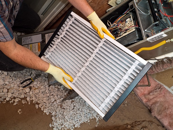 technician changing filter gravel on floor resize